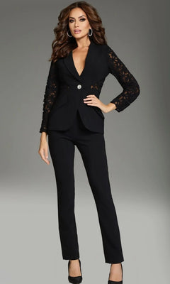 A woman models the Long Jumpsuit: Jovani 39074, featuring lace sleeves and a single button closure, paired with black high heels, against a plain gray background.