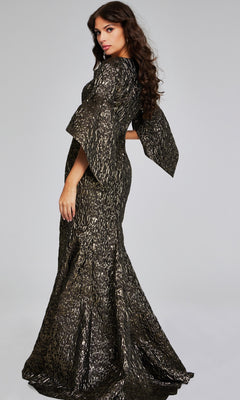 A woman poses in the Jovani 39080 long formal dress, featuring black and gold patterns and flared sleeves, against a plain gray background.