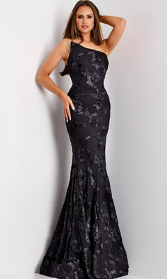 A woman poses in the Jovani 39267 long formal dress—a fitted, floor-length black gown with a floral textured pattern—against a plain light background.