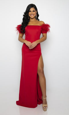 Woman wearing the Ava Presley 39268 Feathered Long Prom Dress with off-the-shoulder feathered banded sleeves and a thigh-high slit, standing and smiling against a plain white background.