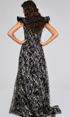A woman stands with hands on hips, her back to the camera, modeling the Long Formal Dress: Jovani 39274—a striking black and gold evening gown—against a plain background.