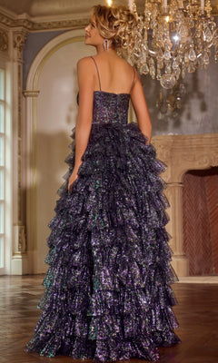 A woman in the Jovani 39305 Ruffled Glitter-Tulle Prom Ball Gown stands with her back to the camera in an elegant, chandelier-lit room.