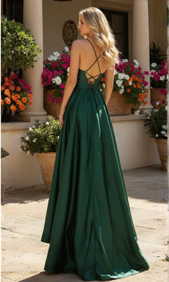 A woman stands outside near potted flowers and columns, wearing the Blondie Nites 3946BN long A-line prom dress featuring a deep green hue, corset-style waist, and crisscross straps.