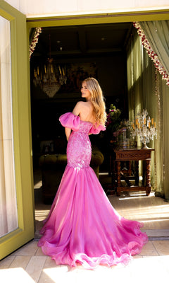 A woman in the Ava Presley 39570 puff-sleeve long prom dress stands in a doorway, looking over her shoulder.