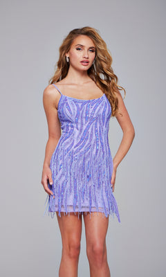 A woman wears the Jovani Fringed Short Sequin Homecoming Dress 39628 in light purple, with beaded fringe detailing, standing against a plain gray background.
