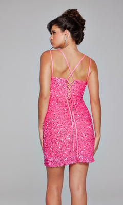 A woman faces away, wearing the Jovani Lace-Up Short Beaded Homecoming Dress 39630 with spaghetti straps and sparkling pink beading, set against a plain light gray background.