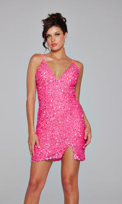 Woman wearing the Jovani Lace-Up Short Beaded Homecoming Dress 39630, a pink sequin mini dress with spaghetti straps and a small front slit, standing against a plain light gray background.
