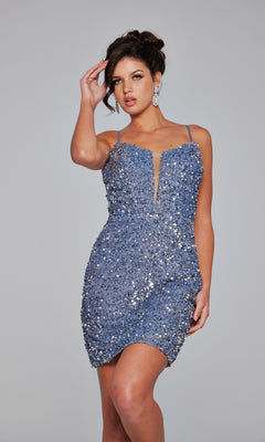 Woman models the Sheer-Back Short Beaded Hoco Dress (Jovani 39635), a fitted, sleeveless blue sequin party dress with thin straps, standing against a plain gray background.