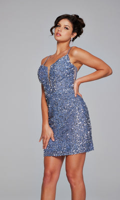 Woman wearing the Jovani 39635 Sheer-Back Short Beaded Hoco Dress, a sleeveless sparkly blue party dress with spaghetti straps, posing against a plain gray background.