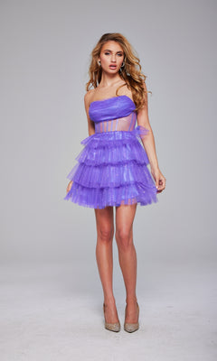 A woman poses against a plain background in the Jovani 39666 Strapless Short Glitter Hoco Dress, featuring ruffled purple tulle and a sheer corset waist, styled with beige high heels.