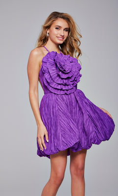 A woman poses against a plain gray background wearing the Rosette Short Bubble Hoco Dress (Jovani 39741), a sleeveless, ruffled purple cocktail dress.