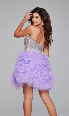 Woman in the Strapless Short Purple Hoco Dress: Jovani 39748, featuring an embellished sweetheart corset and ruffled lavender tulle skirt, stands with her back turned, looking over her shoulder.