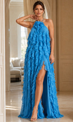 A woman stands indoors on a marble floor, one hand resting on her head, wearing the Long Formal Dress: Jovani 39823 in turquoise—a halter-neck ruffled gown featuring a high slit and an elegant a-line silhouette.