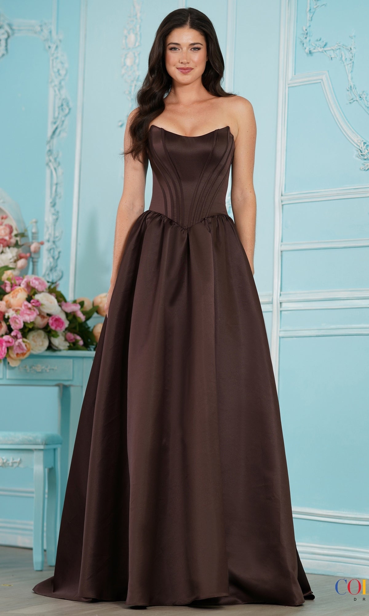 A strapless, brown floor-length Colors Dress 3997 corset prom dress with a full skirt.