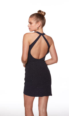 A woman is shown from the back wearing the Alyce 40001 short homecoming dress, featuring a fitted glitter style with crisscross straps and an open back.
