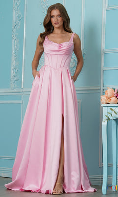 A woman wearing a pink satin Colors Dress 4001 prom dress with a cowl neckline, corset-style bodice, and a high leg slit.