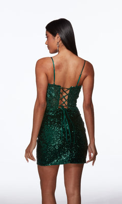 A woman models the Alyce 40034 Pine Green Short Sequin Hoco Dress, featuring spaghetti straps and a lace-up back, against a plain white background.