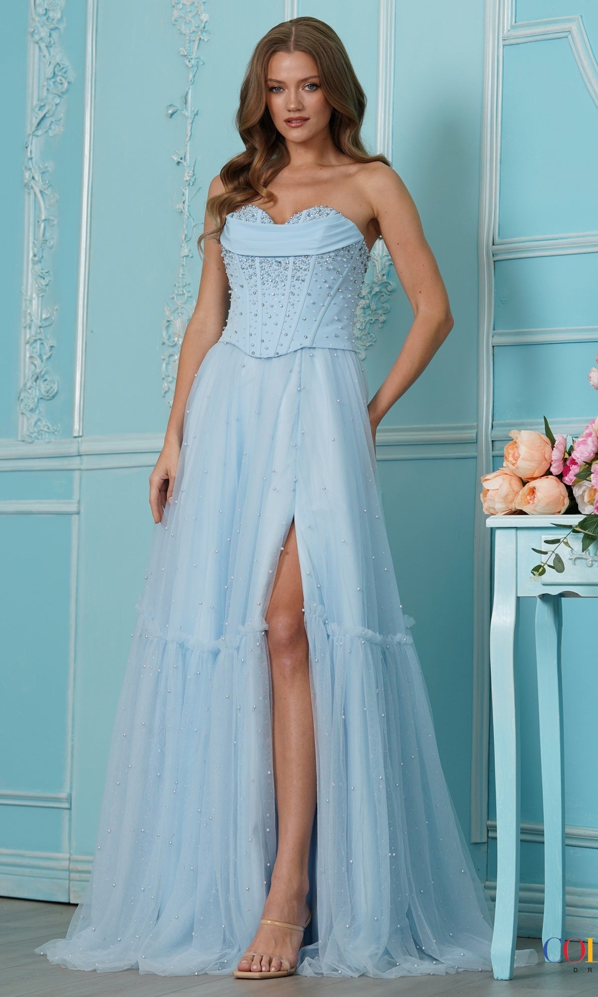 Long Prom Dress: Colors Dress 4003, a blue strapless fairy-style gown with a floor-length silhouette, corset bodice, pearl embellishments, and a high front slit.