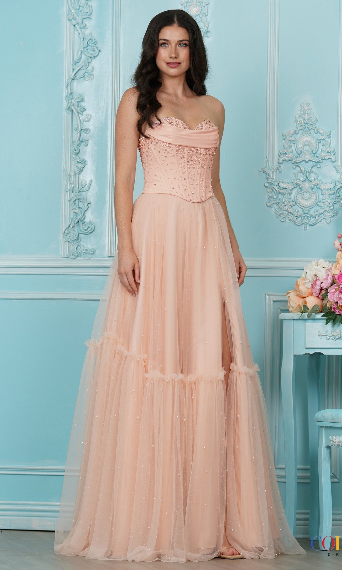 Long Prom Dress: Colors Dress 4003 in blush, featuring a strapless tulle design with a corset-style bodice and a tiered skirt accented with small pearls.