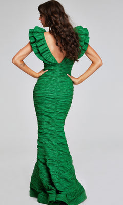 A woman models the Jovani 40044 Long Ruched Formal Dress, featuring a green textured fabric, ruffled sleeves, and a deep V-back as she stands with her back to the camera.