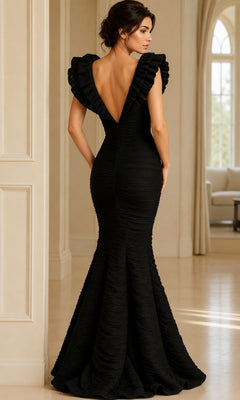 Woman in a fitted Long Ruched Formal Dress: Jovani 40044, featuring ruffled sleeves and an open back, standing indoors facing away from the camera.
