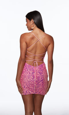 Model facing away in the Alyce 40082 short pink sequin bodycon dress with a crisscross lace-up back. She pairs her long dark hair and hoop earrings for a chic homecoming look.