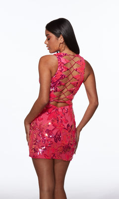 A woman models the Strappy-Back Short Sequin Hoco Dress Alyce 40083—a sleeveless pink party dress with a sequin finish and lattice open back—while standing against a plain white background.