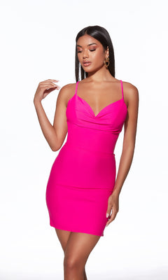 A woman poses against a plain white background in a fitted, bright pink Strappy-Back Short Jersey Hoco Dress: Alyce 40089 with thin straps.