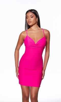 Woman wearing a fitted, bright pink Strappy-Back Short Jersey Hoco Dress: Alyce 40089, standing against a plain white background.