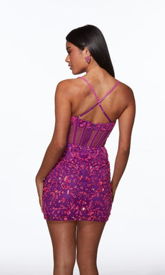 A woman in the Alyce 40093 short homecoming dress—purple sequin mini with crisscross back straps—stands facing away from the camera against a white background.
