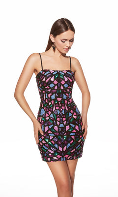 A woman stands against a white background wearing the Alyce 40098 short homecoming dress, featuring thin straps and sequin patterns in a colorful geometric mosaic style.