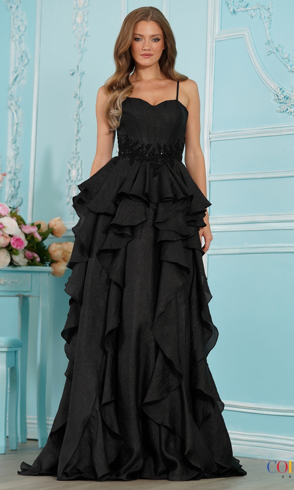 Colors Dress 4011 black floor-length prom dress with a sweetheart neckline, beaded waist, and a cascading ruffle A-line skirt.