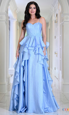 A woman wears a blue Long Prom Dress: Colors Dress 4011, a floor-length gown with a sweetheart neckline, tiered ruffled peplum waist, and cascading ruffles.