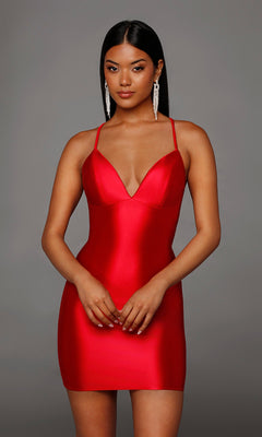 A woman poses against a plain gray background in a sleeveless, fitted red Alyce 40123 Lace-Up Short Satin Sheath Hoco Dress featuring thin straps and a deep neckline.