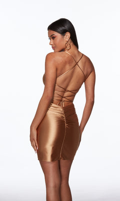 Woman modeling the Alyce 40123 Lace-Up Short Satin Sheath Hoco Dress, featuring a shiny bronze finish and crisscross open back straps, against a plain white background.