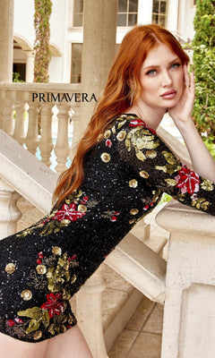 A woman with long red hair poses on a staircase, wearing the One-Sleeve Short Floral-Sequin Party Dress 4014 featuring red and gold floral embroidery. "PRIMAVERA" appears in the background.