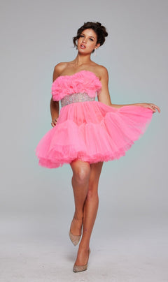 A woman poses in the Jovani 40186 Strapless Short Ruffle Hoco Dress, featuring bright pink tulle, a ruffled bodice, sparkling waistband, earrings, and beige heels against a plain background.