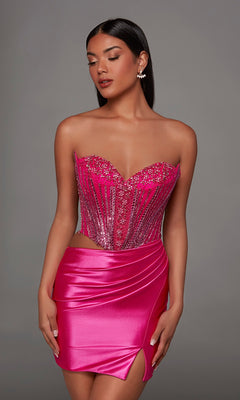 A woman poses in the Alyce 40194 Short Homecoming Dress, showcasing its strapless embellished corset bodice and fitted satin short skirt, set against a plain gray background.
