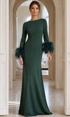 A woman stands indoors, elegantly posing in front of arched doorways while wearing the Jovani 40200 long formal dress, featuring long sleeves and feather trim in a dark green hue.
