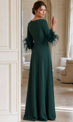 A woman stands indoors in a long, dark green Jovani 40200 formal dress with feathered sleeves, facing away while looking over her shoulder.