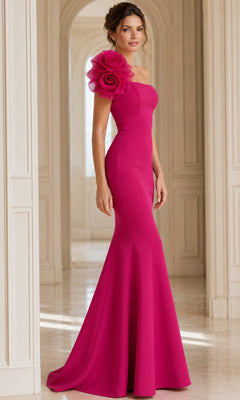 A woman stands in a bright, elegant hallway wearing the Jovani 40201 long formal dress—a floor-length, fitted magenta designer gown featuring a large floral detail on one shoulder.