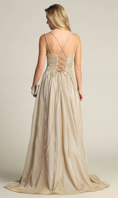 A woman stands facing away, holding a small clutch, in the Lace-Up Back Long Metallic A-Line Prom Dress 4022 featuring shimmering gold fabric, a corset lace-up back, and crisscross straps.