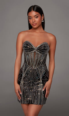 A woman wearing the Alyce 40232 Short Homecoming Dress in Black/Silver, a strapless mini dress adorned with geometric silver rhinestone bead embellishments, stands against a plain gray background. This chic short formal dress is perfect for making a statement at any event.