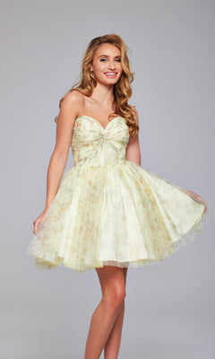 Woman smiles in the Jovani 40374 Strapless Short Yellow Hoco Dress, featuring a fitted bodice and flared skirt, against a plain background.