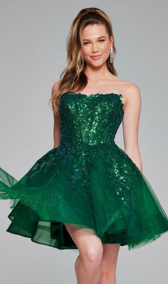 A woman smiles at the camera in the Short Homecoming Dress 40385 by Jovani, featuring a strapless emerald green design with sequin embroidery and a layered short tulle skirt, set against a plain background.