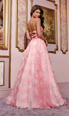A woman wears the Jovani 40402 Cut-Out Long Floral-Print Prom Dress, featuring a strappy open back, as she stands indoors in a room with ornate gold-trimmed paintings and pastel walls.