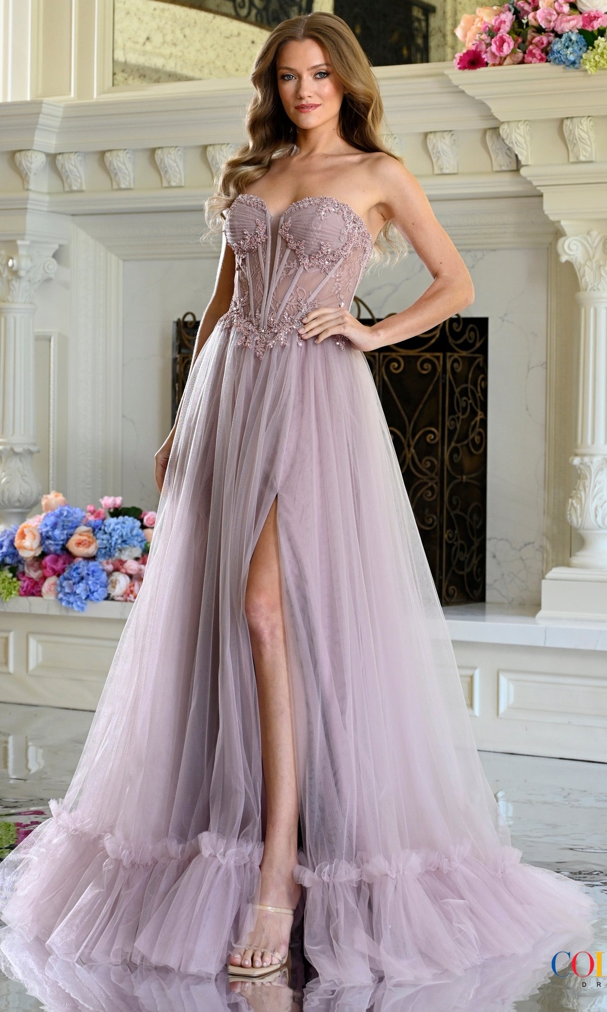 Long Prom Dress: Colors Dress 4041 in dusty rose featuring a sheer lace corset bodice with beaded floral appliqués and a full-length tulle skirt with a high side slit.