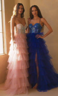 Two women in ball gowns, one pink and one blue, standing side by side.