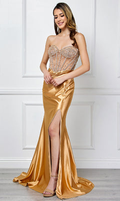 Woman wearing the Strapless Long Prom Gown: Amelia Couture 4049, featuring a beaded bodice and thigh-high slit, stands indoors against a white paneled wall.