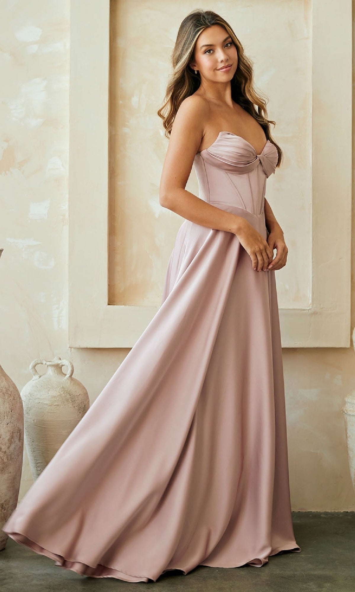 Woman wearing a strapless pink gown in an indoor setting